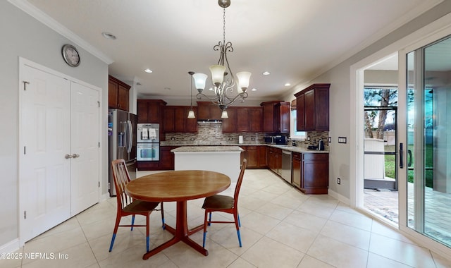 kitchen featuring crown molding, a wealth of natural light, appliances with stainless steel finishes, decorative light fixtures, and a chandelier