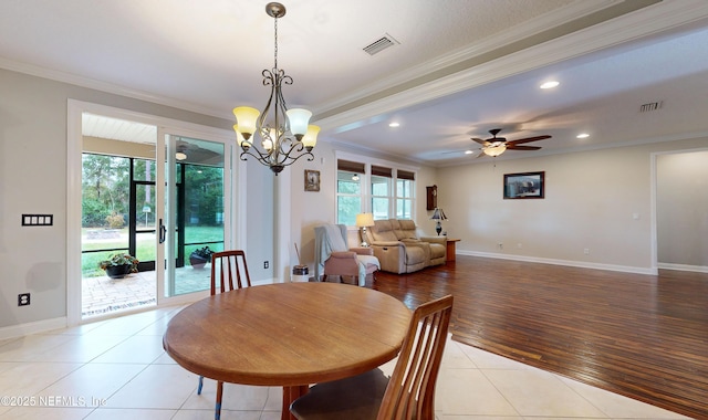 tiled dining space with ceiling fan with notable chandelier and ornamental molding