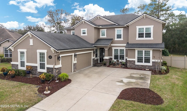 craftsman house featuring a garage and a front lawn