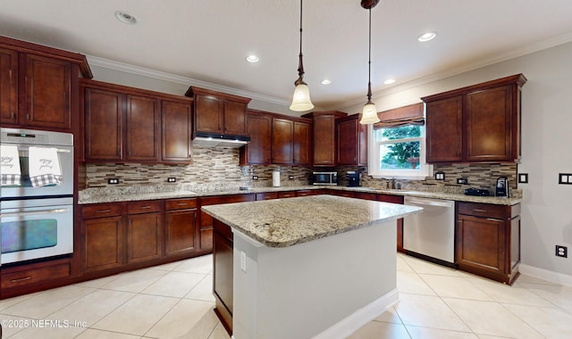 kitchen featuring light stone countertops, a kitchen island, decorative light fixtures, light tile patterned floors, and appliances with stainless steel finishes