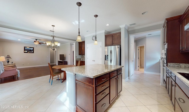 kitchen featuring stainless steel refrigerator with ice dispenser, ceiling fan with notable chandelier, crown molding, decorative light fixtures, and a kitchen island