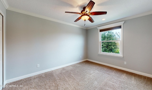 unfurnished room featuring carpet flooring, a textured ceiling, ceiling fan, and ornamental molding