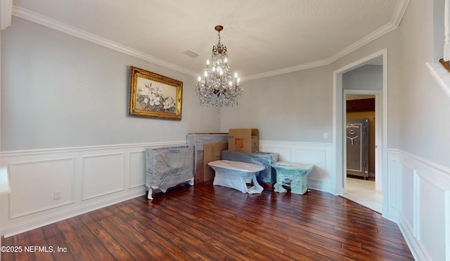 miscellaneous room with ornamental molding, hardwood / wood-style flooring, and a notable chandelier