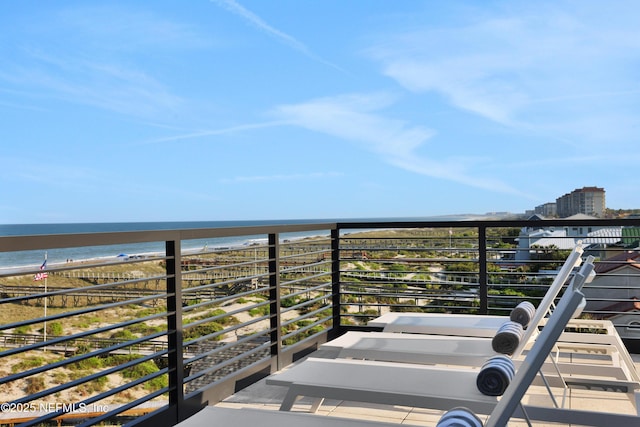 balcony featuring a water view and a beach view