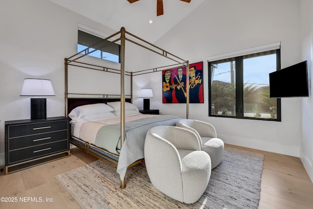 bedroom with high vaulted ceiling, light hardwood / wood-style flooring, and ceiling fan