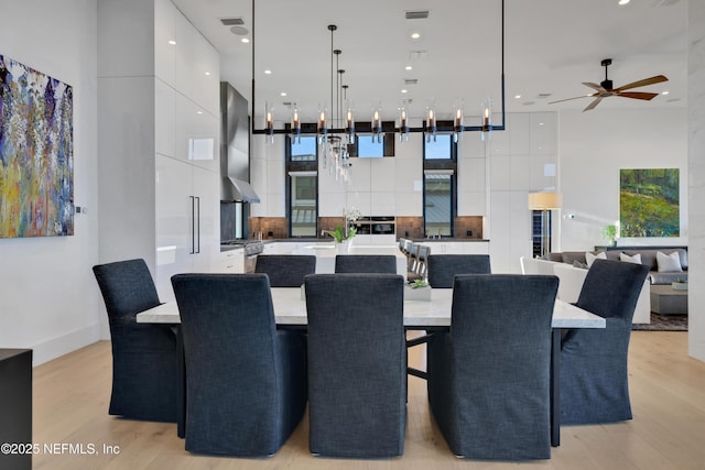 dining area featuring ceiling fan and light hardwood / wood-style floors