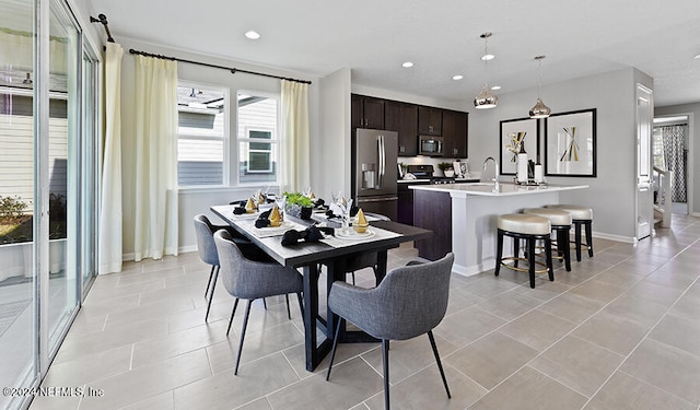 dining area featuring sink, plenty of natural light, and light tile patterned flooring