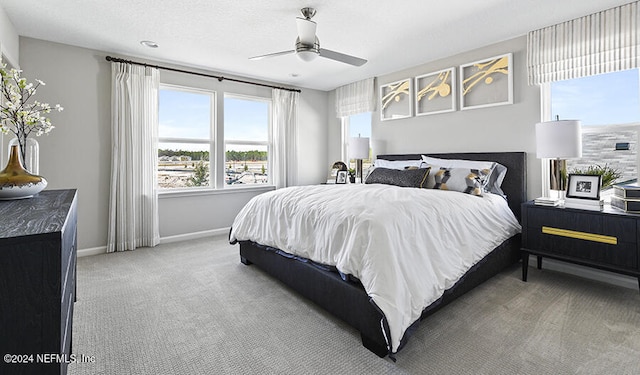 bedroom featuring ceiling fan and carpet