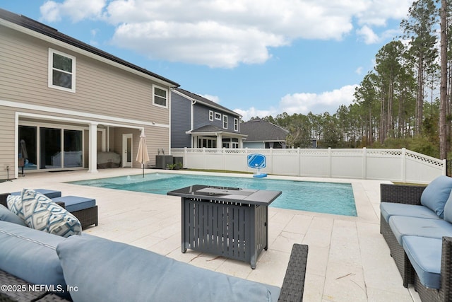 view of pool with central AC unit, outdoor lounge area, and a patio