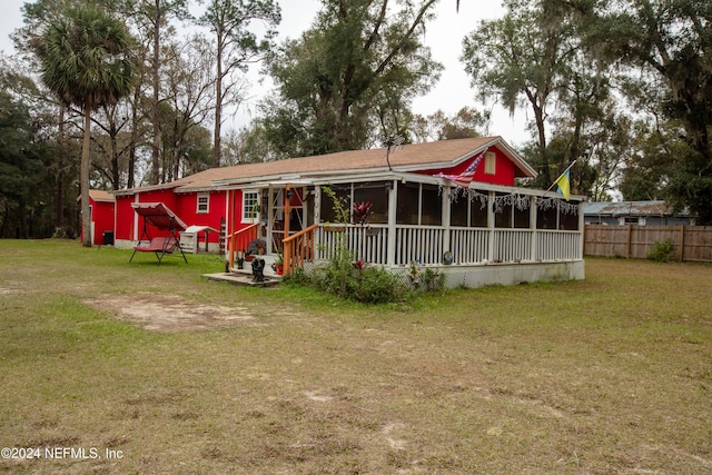 back of house featuring a lawn