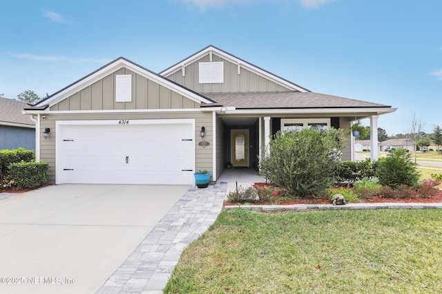 view of front of property featuring a garage and a front lawn