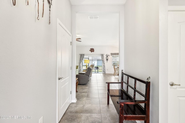 hall with tile patterned floors