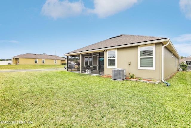 back of house featuring a yard, central air condition unit, and a sunroom