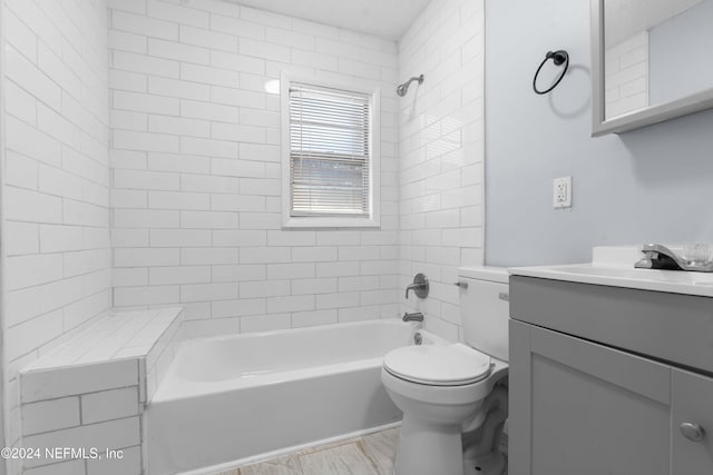 full bathroom with vanity, toilet, and tiled shower / bath