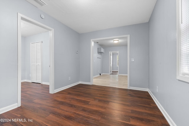 spare room with dark wood-type flooring