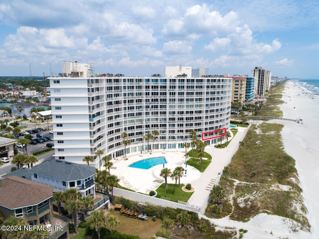 exterior space with a water view and a beach view