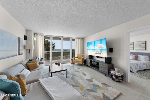 living room with floor to ceiling windows and a textured ceiling