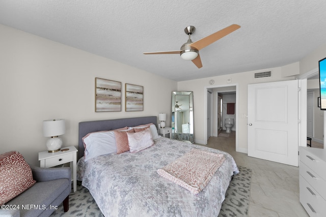 bedroom featuring ceiling fan and a textured ceiling