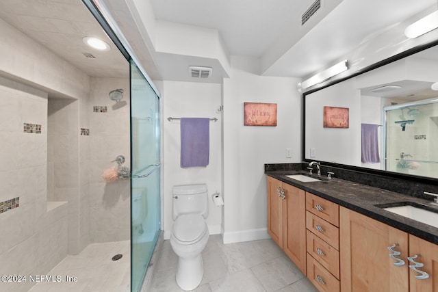 bathroom with an enclosed shower, vanity, and toilet