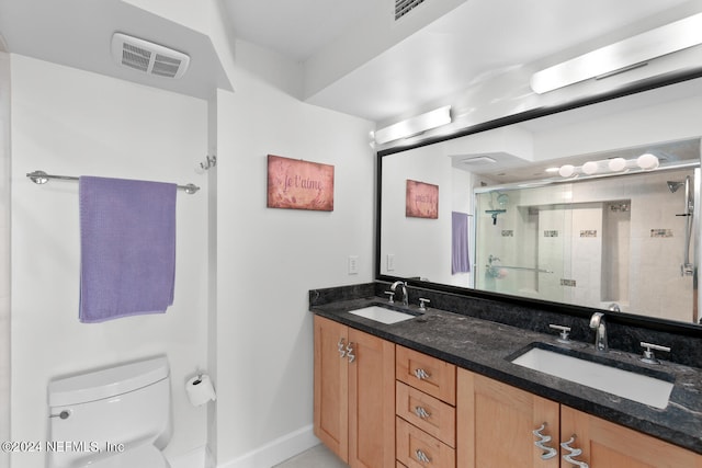 bathroom featuring toilet, vanity, and walk in shower