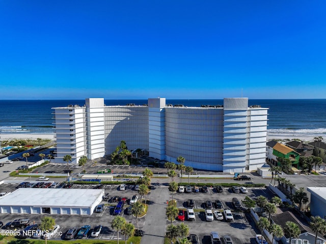 aerial view with a water view and a beach view