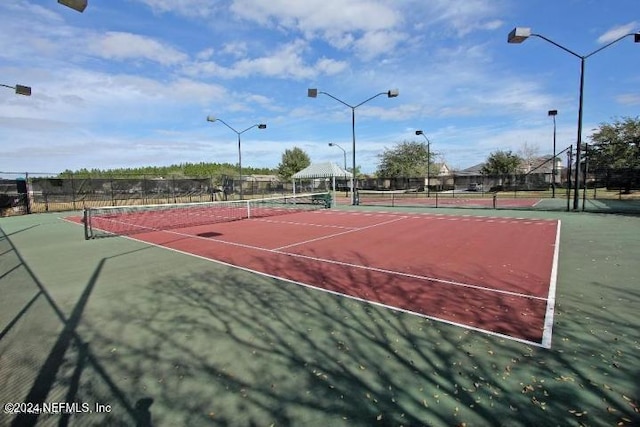 view of tennis court featuring a gazebo and basketball court