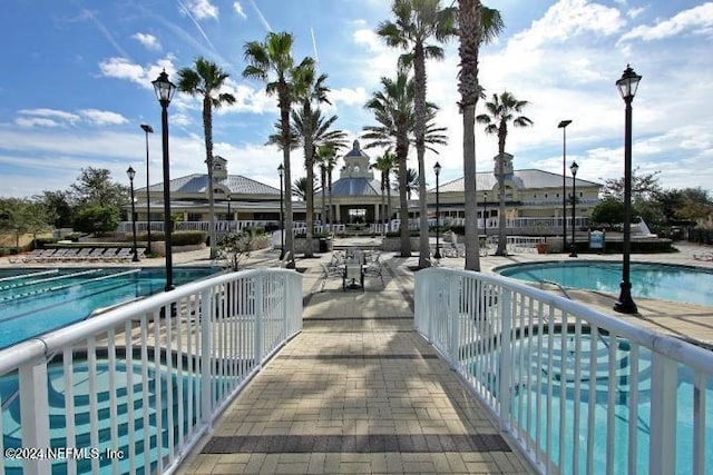 view of pool with a jacuzzi and a patio area