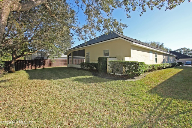 view of property exterior with a lawn