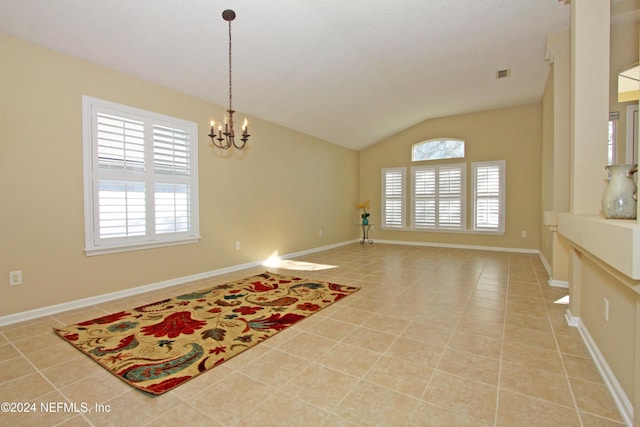 interior space with light tile patterned flooring, lofted ceiling, and a chandelier