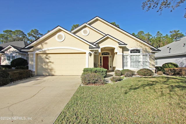 view of front of home with a garage and a front yard