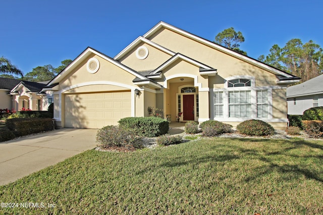 ranch-style home featuring a garage and a front yard