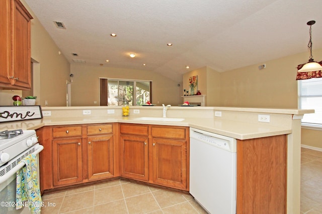 kitchen with sink, white appliances, a wealth of natural light, and vaulted ceiling