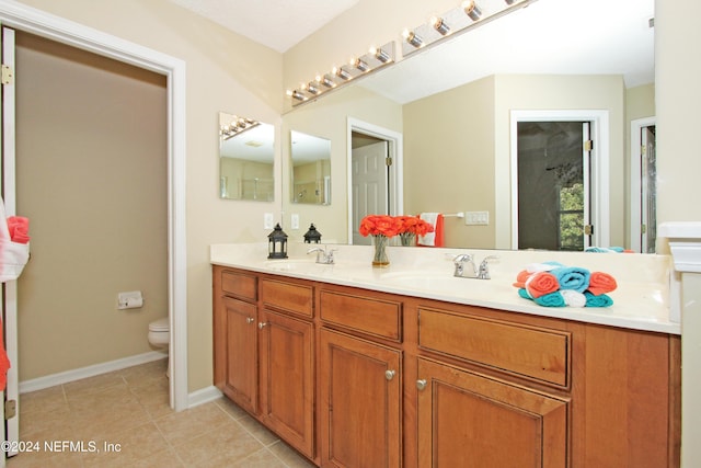 bathroom featuring vanity, tile patterned floors, and toilet