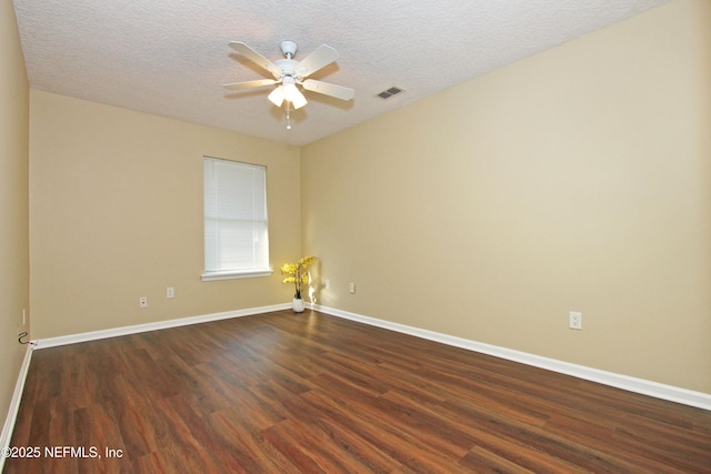 unfurnished room with ceiling fan, dark hardwood / wood-style flooring, and a textured ceiling