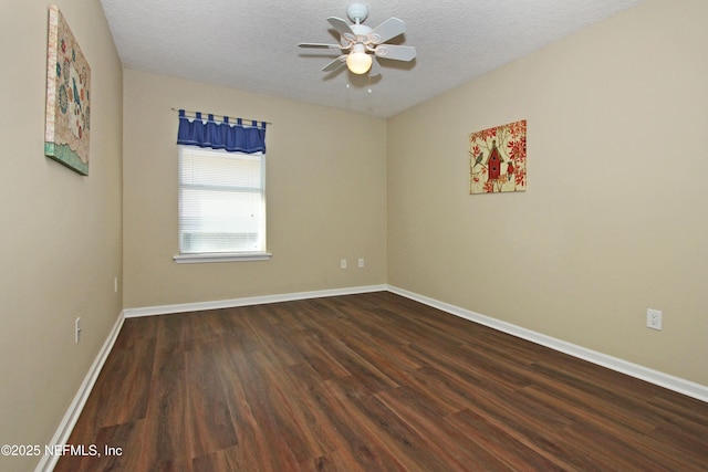 unfurnished room featuring ceiling fan, dark wood-type flooring, and a textured ceiling