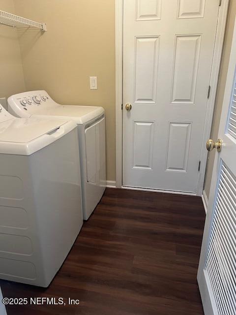 washroom featuring dark hardwood / wood-style flooring and separate washer and dryer