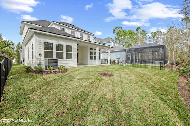 back of house with a lanai, central AC, and a yard