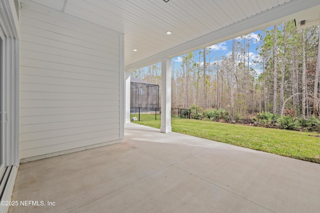 view of patio with glass enclosure