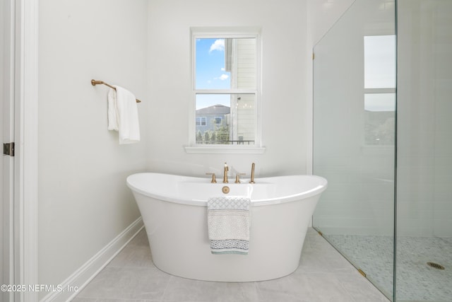 bathroom featuring tile patterned flooring and a bathtub