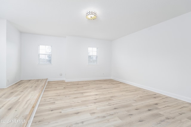 empty room with light hardwood / wood-style flooring