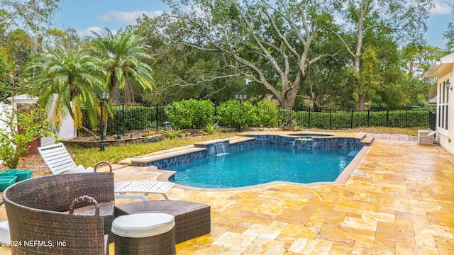 view of swimming pool featuring an in ground hot tub, pool water feature, and a patio area