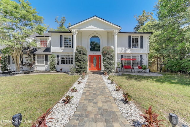 greek revival inspired property with a front lawn