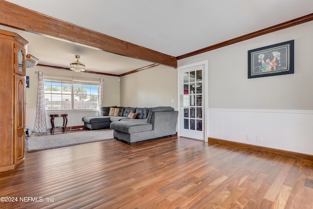 living room featuring crown molding, beamed ceiling, and wood-type flooring