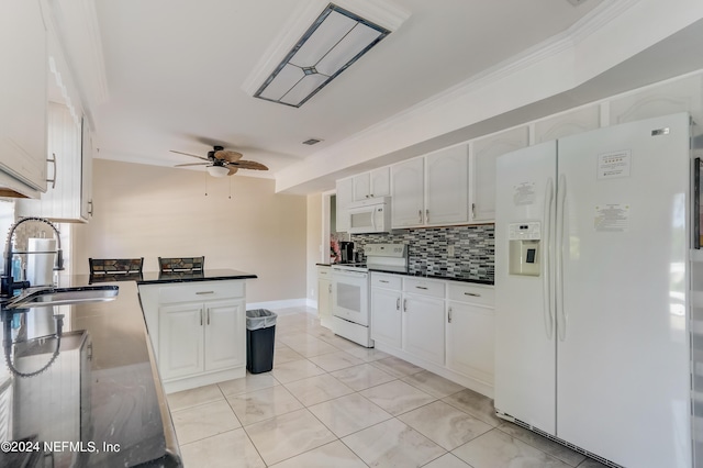 kitchen with tasteful backsplash, white appliances, ceiling fan, sink, and white cabinetry