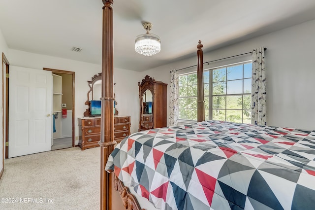 carpeted bedroom featuring a notable chandelier