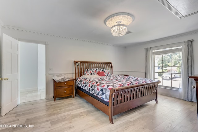 bedroom featuring light wood-type flooring and a notable chandelier