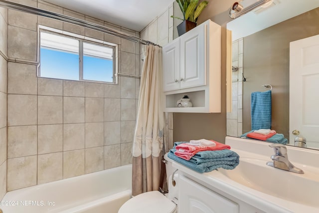 full bathroom featuring shower / bath combination with curtain, vanity, and toilet