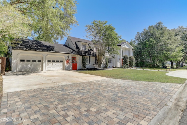 view of front of home with a front lawn and a garage