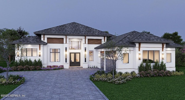 view of front of home with a shingled roof, a front lawn, stucco siding, french doors, and decorative driveway