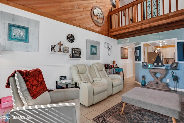 tiled living room featuring a notable chandelier and wooden ceiling